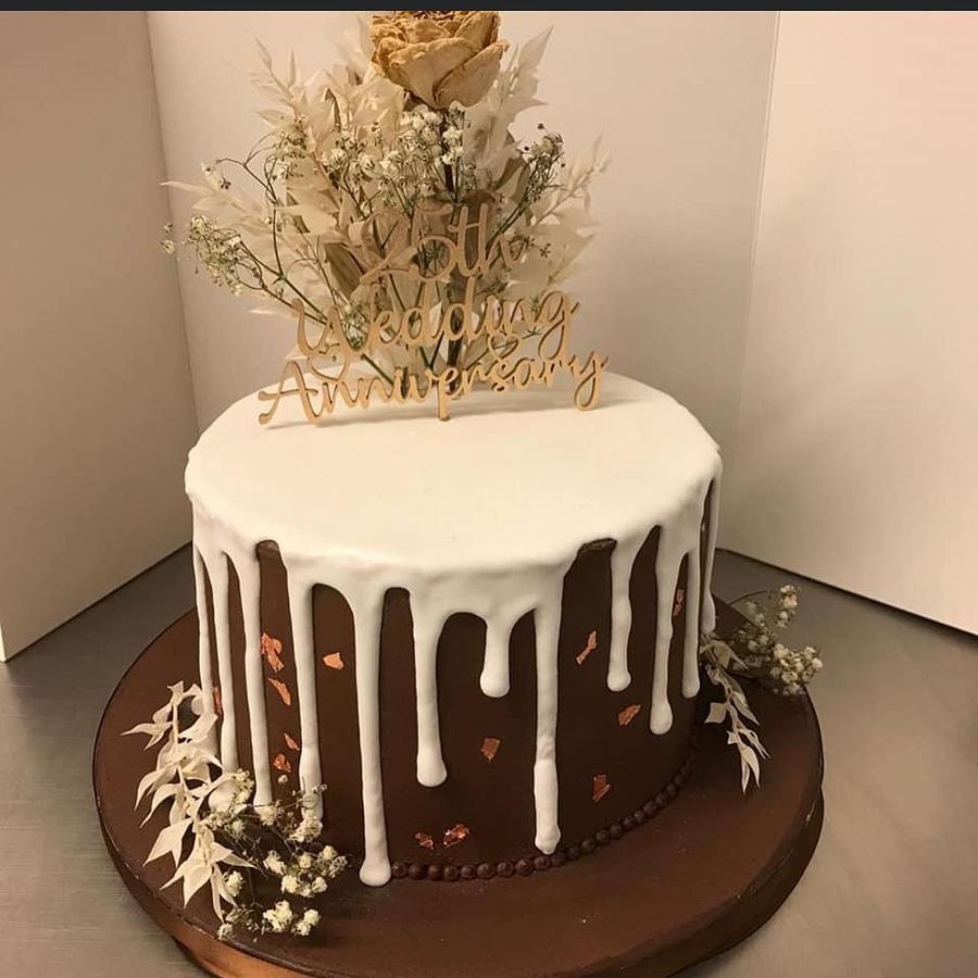 Chocolate drip 25th wedding anniversary cake with dried flowers