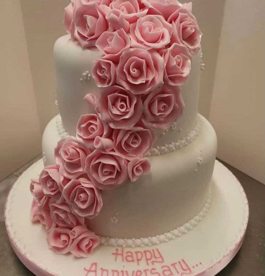 Two-tier anniversary cake with cascading pink sugar roses