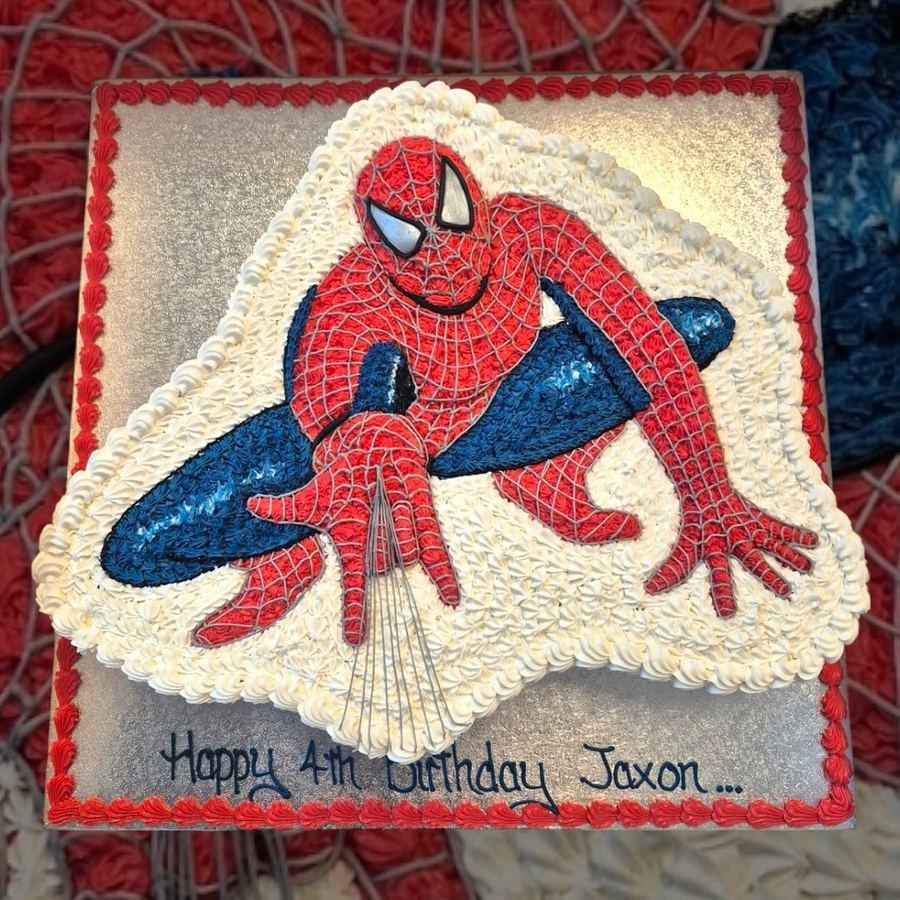 Piped superhero 4th birthday cake
